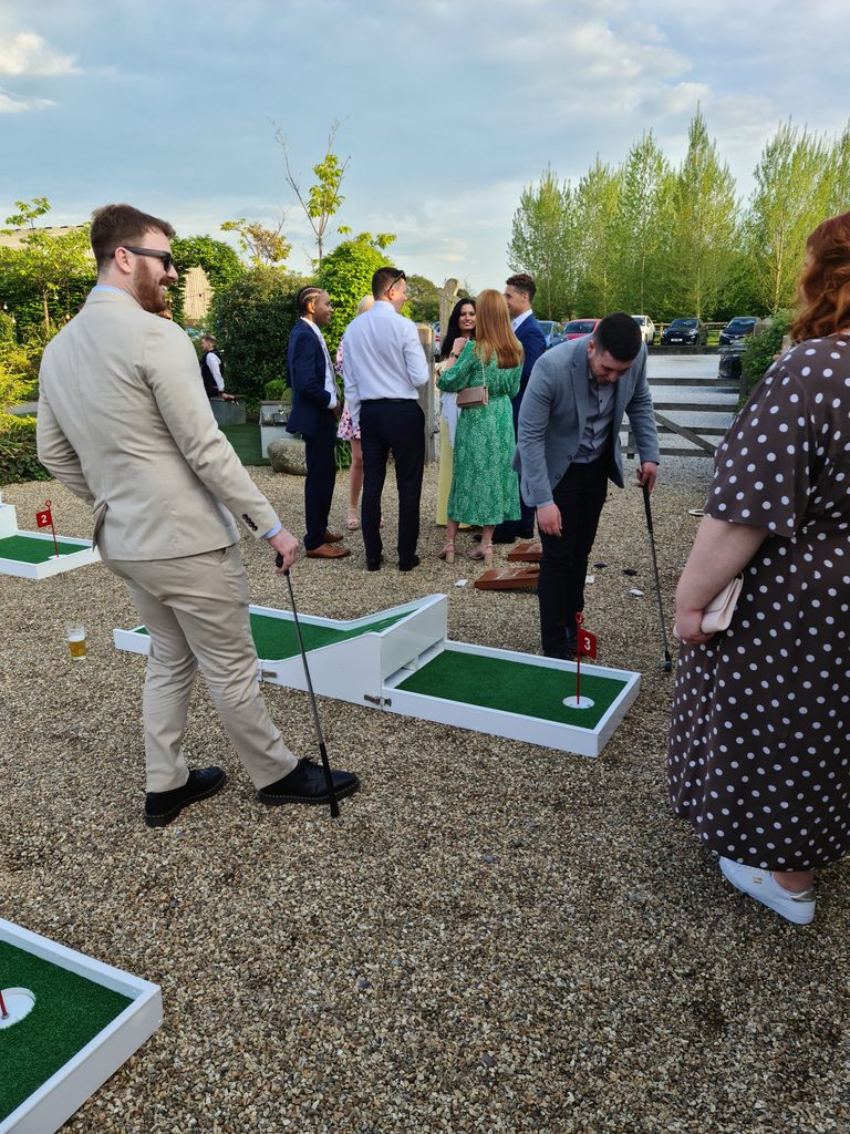 wedding mini golf players on hole no3 enjoying drinks reception. on our reviews webpage