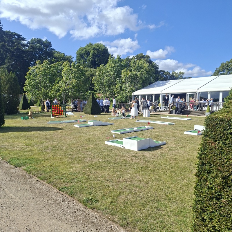 Mini Golf Cheshire at Combermere Abbey set up on the lawn with guests playing crazy golf