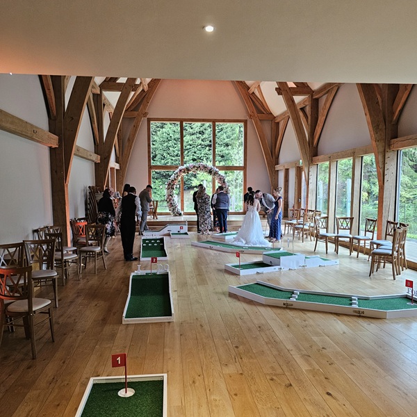 Mini Golf Staffordshire at Mill Barns. Gusts enjoying crazy golf inside the wedding room
